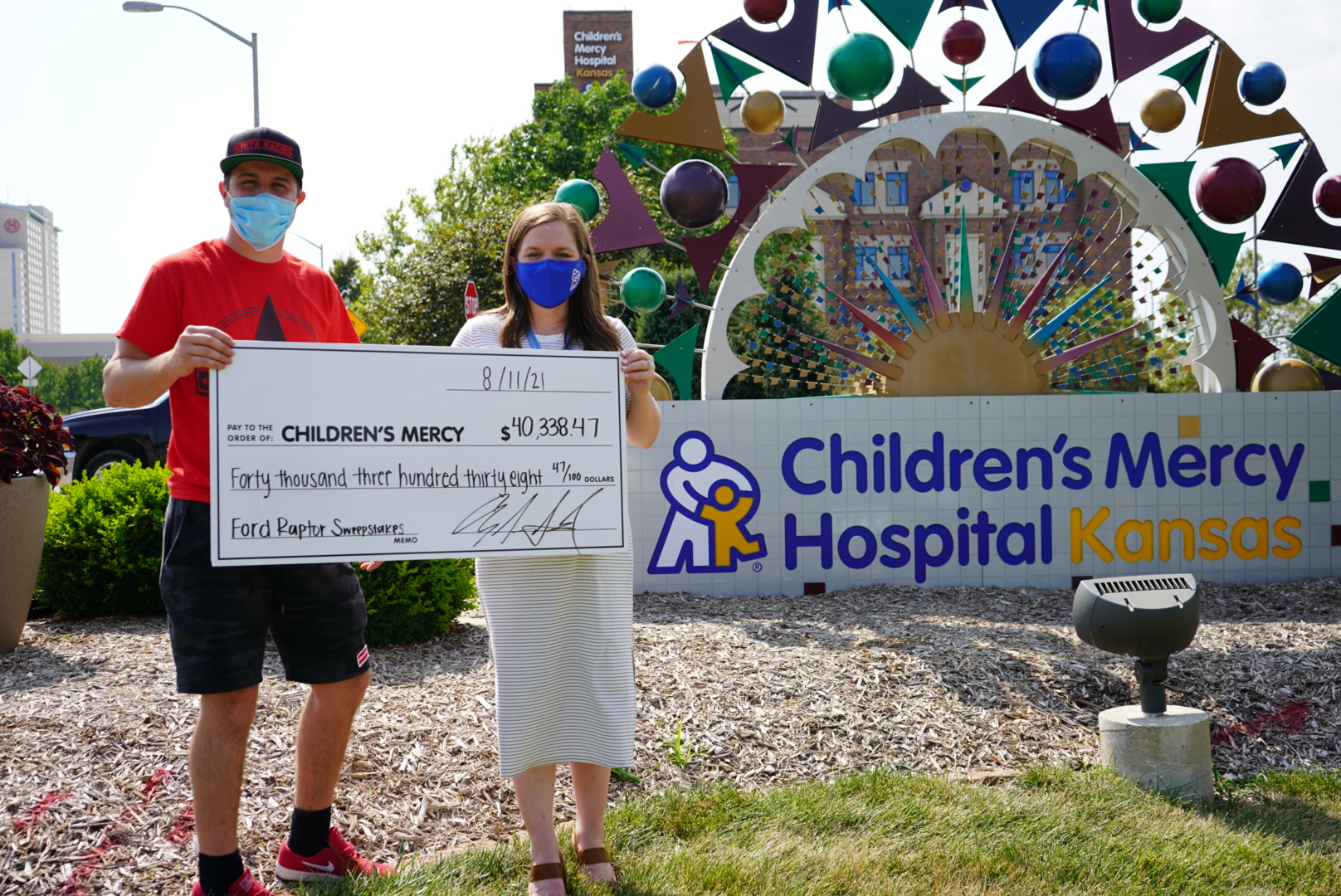 Anthony Gockel, owner and builder of AG Custom Homes, with a donation check to Children's Mercy Hospital Kansas